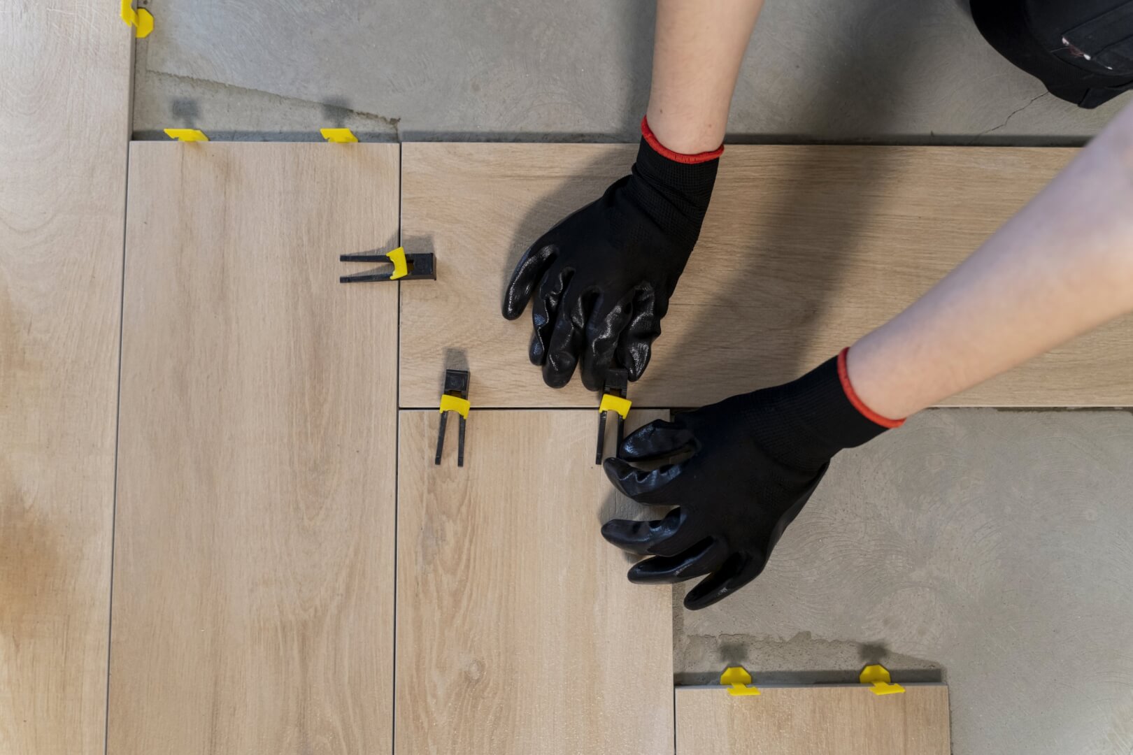 top-view-worker-tiling-floor